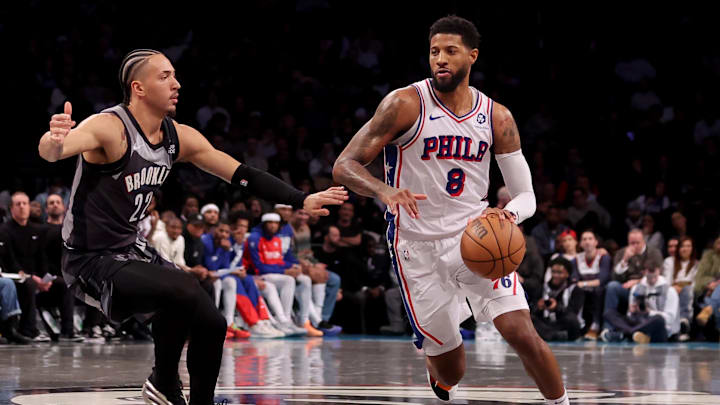 Feb 12, 2025; Brooklyn, New York, USA; Philadelphia 76ers forward Paul George (8) brings the ball up court against Brooklyn Nets forward Jalen Wilson (22) during the fourth quarter at Barclays Center. Mandatory Credit: Brad Penner-Imagn Images