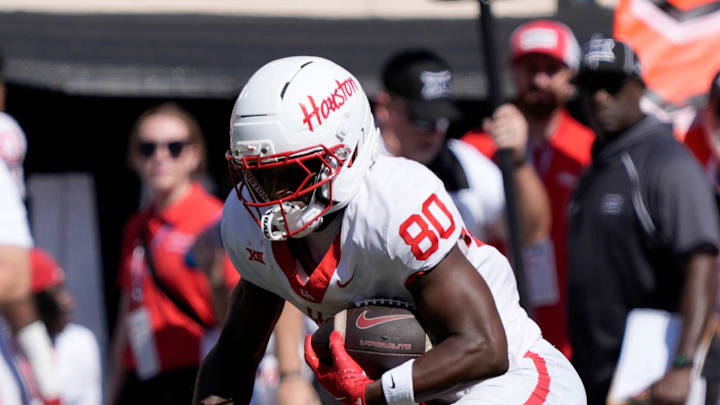 Houston Cougars wide receiver Jaquise Martin (80) steps over Oklahoma State Cowboys cornerback Cam Smith (3) during a college football game between the Oklahoma State Cowboys (OSU) and the Houston Cougars at Boone Pickens Stadium in Stillwater, Okla., Saturday, Oct. 11, 2025. Houston won 39-17.
