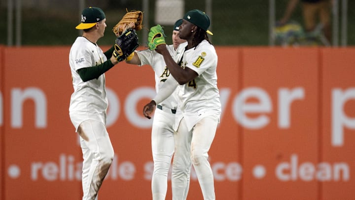 Jun 6, 2025; West Sacramento, California, USA; Athletics outfielders JJ Bleday (33), Seth Brown and Lawrence Butler celebrate their 5-4 victory over the Baltimore Orioles at Sutter Health Park. Mandatory Credit: D. Ross Cameron-Imagn Images