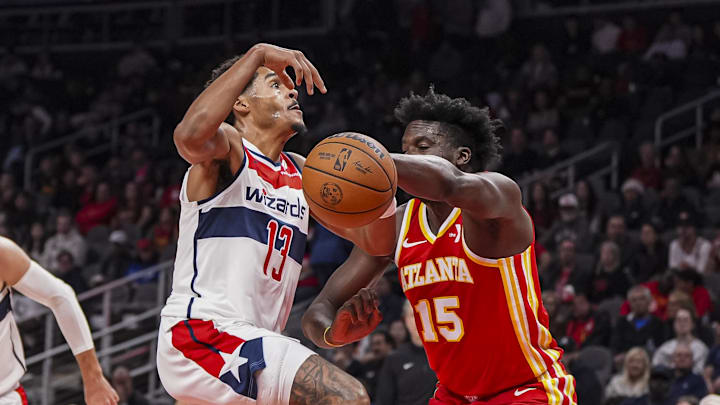 Oct 28, 2024; Atlanta, Georgia, USA; Washington Wizards guard Jordan Poole (13) is stripped of the ball by Atlanta Hawks center Clint Capela (15) during the first half at State Farm Arena. Mandatory Credit: Dale Zanine-Imagn Images
