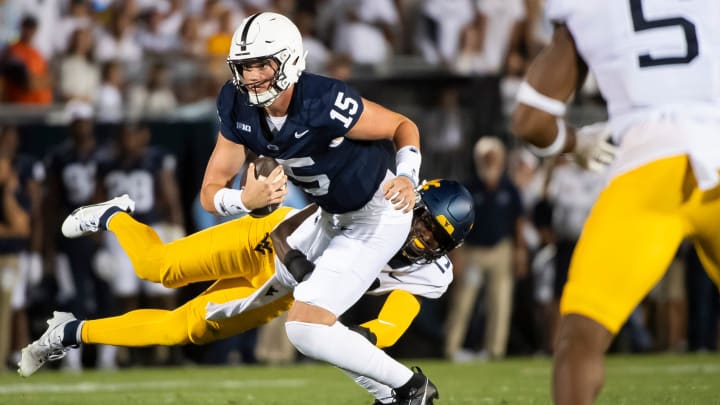 Penn State quarterback Drew Allar slips a sack attempt from West Virginia linebacker Trey Lathan during the 2023 season opener at Beaver Stadium.