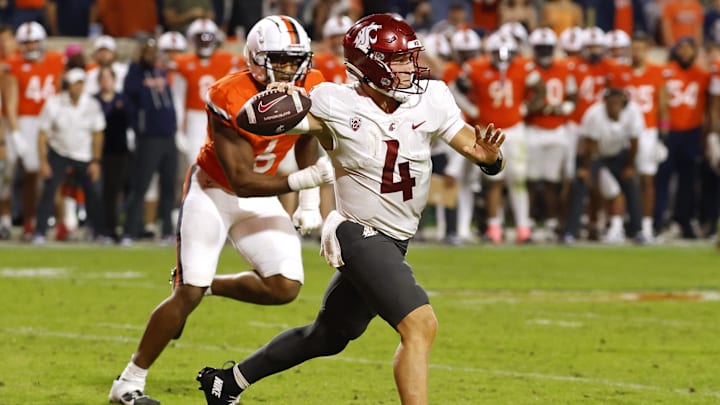 Oct 18, 2025; Charlottesville, Virginia, USA; Washington State Cougars quarterback Zevi Eckhaus (4) throws an interception while scrambling from Virginia Cavaliers defensive end Cazeem Moore (6) in the fourth quarter at Scott Stadium. Mandatory Credit: Geoff Burke-Imagn Images Oct 18, 2025; Charlottesville, Virginia, USA; Washington State Cougars quarterback Zevi Eckhaus (4) throws an interception while scrambling from Virginia Cavaliers defensive end Cazeem Moore (6) in the fourth quarter at Scott Stadium. Mandatory Credit: Geoff Burke-Imagn Images