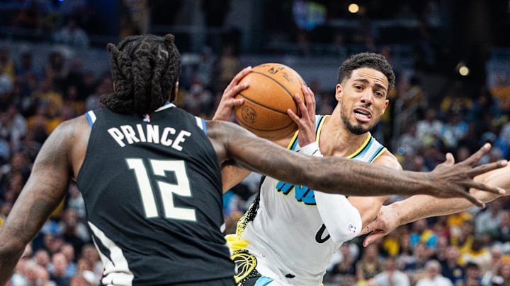 Apr 22, 2025; Indianapolis, Indiana, USA; Indiana Pacers guard Tyrese Haliburton (0) dribbles the ball while Milwaukee Bucks forward Taurean Prince (12) defends during game two of first round for the 2024 NBA Playoffs at Gainbridge Fieldhouse. Mandatory Credit: Trevor Ruszkowski-Imagn Images