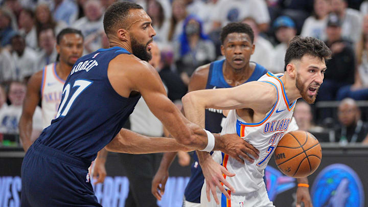 May 24, 2025; Minneapolis, Minnesota, USA; Oklahoma City Thunder forward Chet Holmgren (7) dribbles the ball past Minnesota Timberwolves center Rudy Gobert (27) during the first half in game three of the western conference finals for the 2025 NBA Playoffs at Target Center. Mandatory Credit: Brad Rempel-Imagn Images