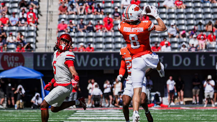 Oct 4, 2025; Tucson, Arizona, USA; Oklahoma State safety Parker Robertson (8) intercepts a pass intended for Arizona Wildcats wide receiver Gil Richardson (5) during the second quarter at Arizona Stadium. Mandatory Credit: Aryanna Frank-Imagn Images