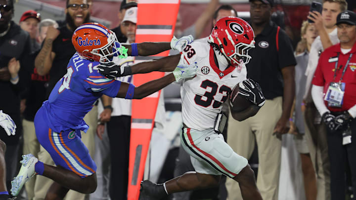 Florida Gators defensive back Jordan Castell (14) pushes Georgia Bulldogs running back Chauncey Bowens (33) out of bounds during the second half of an NCAA football game at Everbank Stadium in Jacksonville, FL on Saturday, November 1, 2025. Georgia won 24-20. [Alan Youngblood/Gainesville Sun]