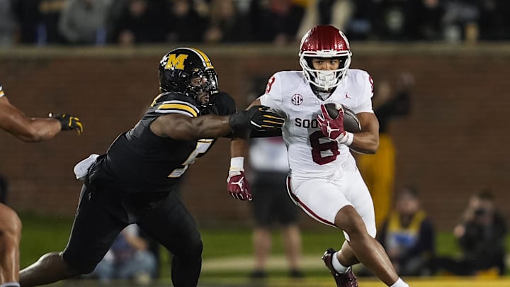 Nov 9, 2024; Columbia, Missouri, USA; Oklahoma Sooners running back Taylor Tatum (8) runs the ball against Missouri Tigers defensive tackle Kristian Williams (5) during the first half at Faurot Field at Memorial Stadium. Mandatory Credit: Jay Biggerstaff-Imagn Images