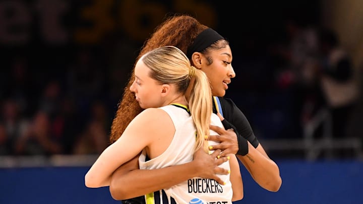 May 29, 2025; Chicago, Illinois, USA; Chicago Sky forward Angel Reese (5) and Dallas Wings guard Paige Bueckers (5) hug prior to a game at the Wintrust Arena. Mandatory Credit: Patrick Gorski-Imagn Images