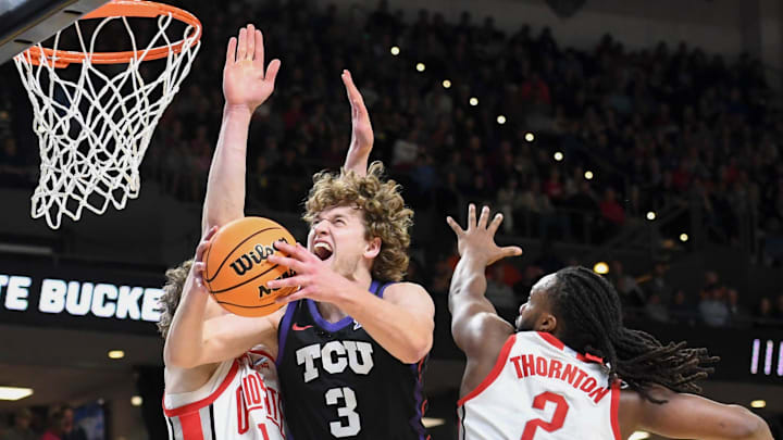 Ohio State Buckeyes center Christoph Tilly (13) and Ohio State Buckeyes guard Bruce Thornton (2) defend the shot of TCU Horned Frogs guard Liutauras Lelevicius (3) Thursday, March 19, 2026, during the NCAA Men’s Basketball Tournament first round game at Bon Secours Wellness Arena in Greenville, South Carolina.