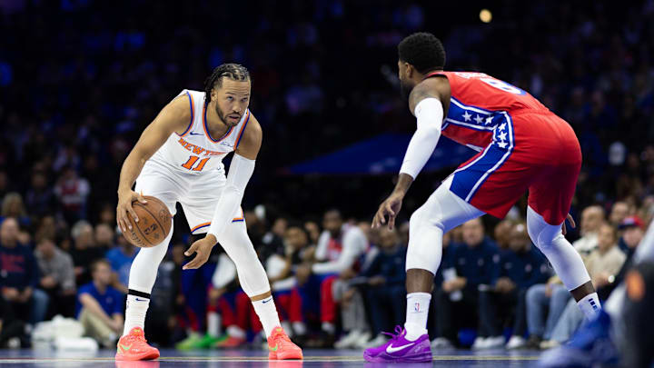 Nov 12, 2024; Philadelphia, Pennsylvania, USA; New York Knicks guard Jalen Brunson (11) controls the ball against Philadelphia 76ers forward Paul George (8) during the first quarter at Wells Fargo Center. Mandatory Credit: Bill Streicher-Imagn Images