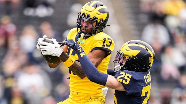 Team Maize wide receiver Donaven McCulley (13) makes a catch against Team Blue defensive back Mason Curtis (25) during the first half of the spring game at Michigan Stadium in Ann Arbor on Saturday, April 19, 2025.