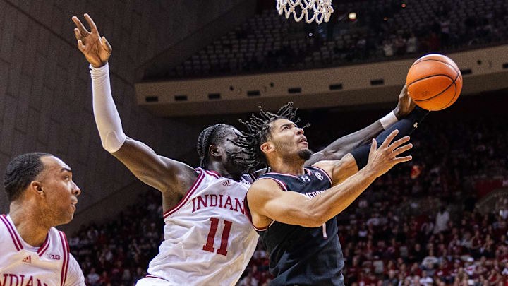 Nov 16, 2024; Bloomington, Indiana, USA; South Carolina Gamecocks guard Jacobi Wright (1) shoots the ball while Indiana Hoosiers center Oumar Ballo (11) defends in the second half at Simon Skjodt Assembly Hall. Mandatory Credit: Trevor Ruszkowski-Imagn Images