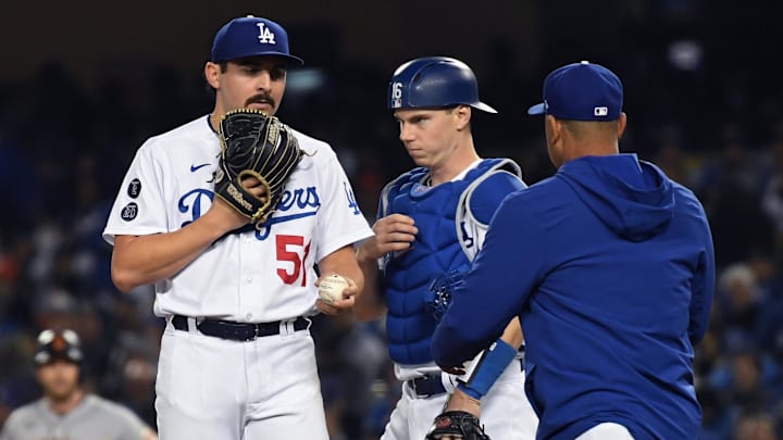 Oct 12, 2021; Los Angeles, California, USA; Los Angeles Dodgers manager Dave Roberts (right) takes the ball from  relief pitcher Alex Vesia (51) during a pitching change in the seventh inning against the San Francisco Giants in game four of the 2021 NLDS at Dodger Stadium. Mandatory Credit: Richard Mackson-Imagn Images