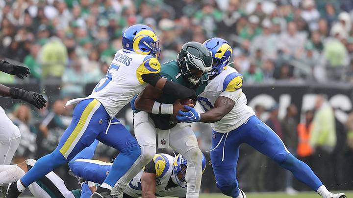Oct 4, 2026; Philadelphia, Pennsylvania, USA;  Los Angeles Rams linebacker Byron Young (0) and safety Kamren Kinchens (5) sack Philadelphia Eagles quarterback Jalen Hurts (1) during the first half at Lincoln Financial Field.  Mandatory Credit: Bill Streicher-Imagn Images