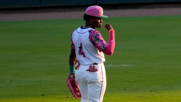 Apr 18, 2025; North Augusta, South Carolina, USA; Augusta GreenJackets Isaiah Drake (4) stands in the outfield during the Augusta GreenJackets and Myrtle Beach baseball game at SRP Park. The Augusta GreenJackets unveiled their new Augusta Azalea uniforms. Mandatory Credit: Katie Goodale - Augusta Chronicle/USA TODAY NETWORK