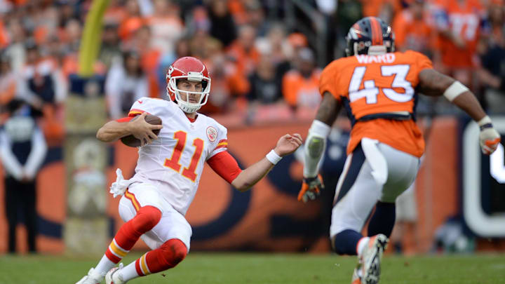 Nov 15, 2015; Denver, CO, USA; Kansas City Chiefs quarterback Alex Smith (11) slides as Denver Broncos strong safety T.J. Ward (43) closes in in the second quarter at Sports Authority Field at Mile High. Mandatory Credit: Ron Chenoy-Imagn Images