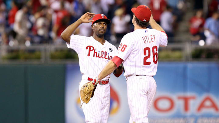 Jul 25, 2014; Philadelphia, PA, USA; Philadelphia Phillies shortstop Jimmy Rollins (11) and second baseman Chase Utley (26) high-five each other at the conclusion of a game.