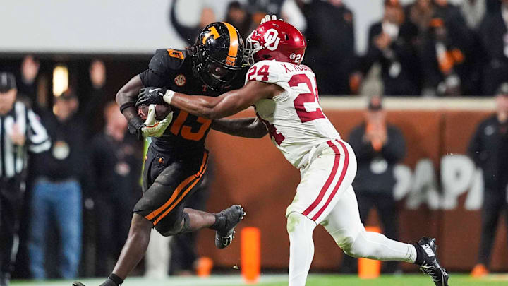 Oklahoma running back Xavier Robinson (24) tackles Tennessee linebacker Edwin Spillman (13) after Spillman intercepts the ball during a NCAA football game between the Tennessee Volunteers and Oklahoma Sooners at Neyland Stadium in Knoxville, Tenn., on November 1, 2025.