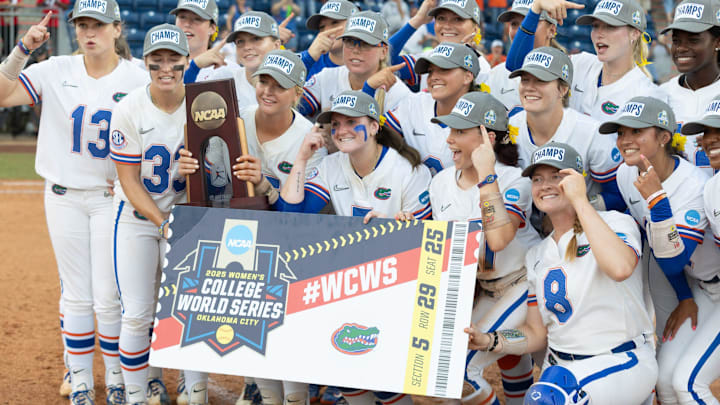 Florida gator pose for photos as they celebrate their 5-2 win over Georgia during the third game of the NCAA super regionals softball game in Gainesville, FL on Sunday, May 25, 2025. Florida goes to the college world series in Oklahoma. [Alan Youngblood/Gainesville Sun]