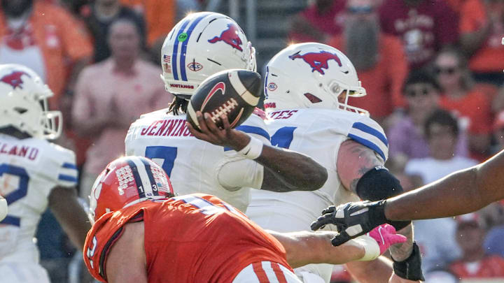 Oct 18, 2025; Clemson, South Carolina, USA; Southern Methodist Mustangs quarterback Kevin Jennings (7) passes near Clemson Tigers defensive end Will Heldt (13) during the second quarter at Memorial Stadium. Mandatory Credit: Ken Ruinard-GREENVILLE NEWS-USA TODAY Network via Imagn Images