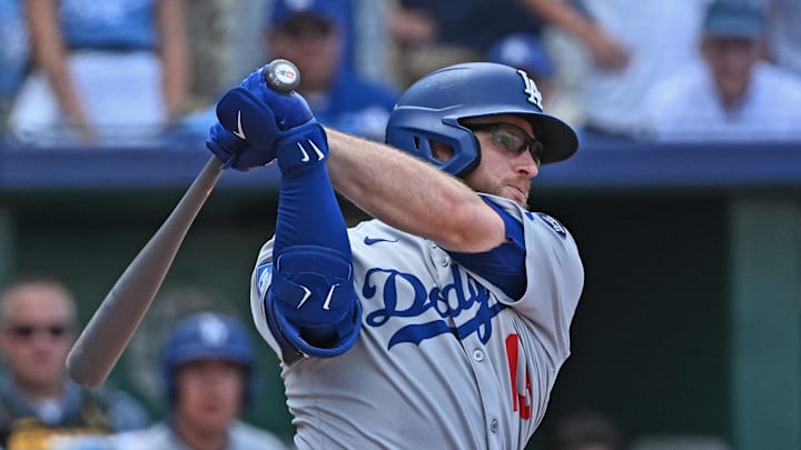 Dodgers third baseman Max Muncy (13) hits an RBI single in the ninth inning against the Kansas City Royals at Kauffman Stadium on June 28.