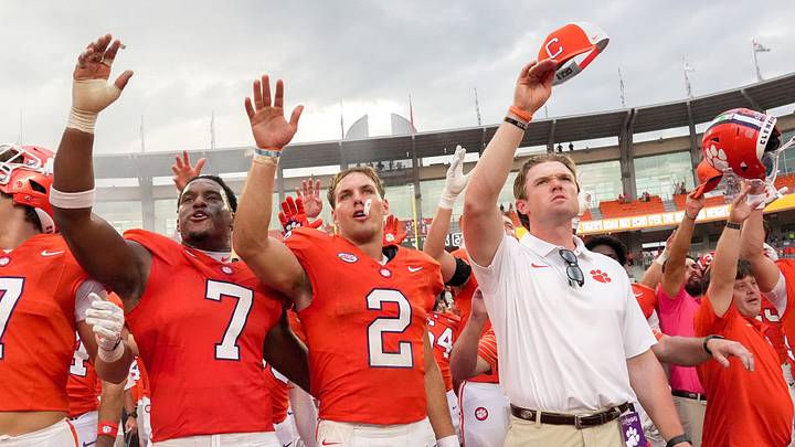 Clemson linebacker Jeremiah Alexander (7), quarterback Tait Reynolds (2) and assistant coach Hunter Helms sing the alma mater after Clemson's victory Clemson linebacker Jeremiah Alexander (7), quarterback Tait Reynolds (2) and assistant coach Hunter Helms sing the alma mater after Clemson's victory