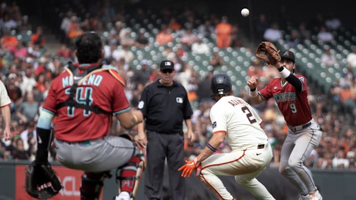 Sep 10, 2025; San Francisco, California, USA; San Francisco Giants shortstop Willy Adames (2) is caught in a rundown between third and home as Arizona Diamondbacks catcher Gabriel Moreno (14) and third baseman Blaze Alexander (9) exchange throws during the seventh inning at Oracle Park. Sep 10, 2025; San Francisco, California, USA; San Francisco Giants shortstop Willy Adames (2) is caught in a rundown between third and home as Arizona Diamondbacks catcher Gabriel Moreno (14) and third baseman Blaze Alexander (9) exchange throws during the seventh inning at Oracle Park.