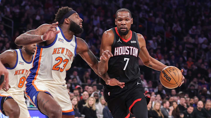 Feb 21, 2026; New York, New York, USA;  Houston Rockets forward Kevin Durant (7) drives past New York Knicks center Mitchell Robinson (23) in the first quarter at Madison Square Garden. Mandatory Credit: Wendell Cruz-Imagn Images