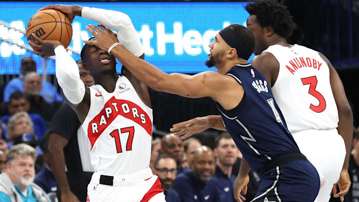 Nov 21, 2023; Orlando, Florida, USA; Orlando Magic guard Jalen Suggs (4) fouls Toronto Raptors guard