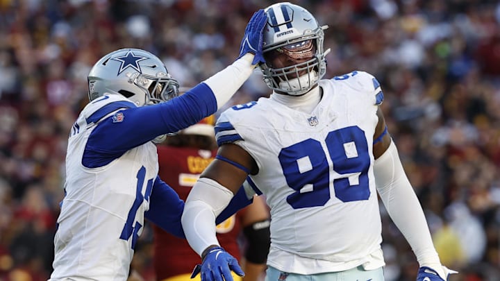 Nov 24, 2024; Landover, Maryland, USA; Dallas Cowboys defensive end Chauncey Golston (99) celebrates with Cowboys linebacker DeMarvion Overshown (13) after batting down a pass against the Washington Commanders during the third quarter at Northwest Stadium.  