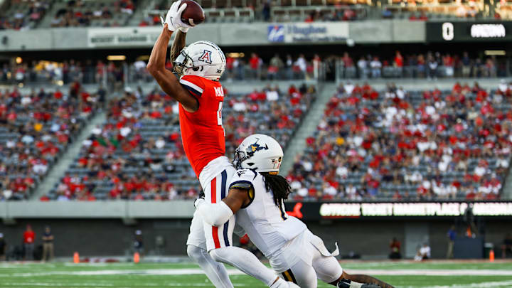 Oct 26, 2024; Tucson, Arizona, USA; Arizona Wildcats wide receiver Tetairoa McMillan (4) catches the ball during the second quarter against the West Virginia Mountaineers at Arizona Stadium. 
