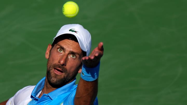 Novak Djokovic, of Serbia, serves to Carlos Alcaraz, of Spain, during the men   s singles final of
