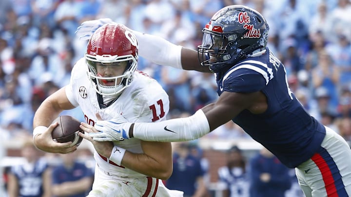 Oct 26, 2024; Oxford, Mississippi, USA; Mississippi Rebels linebacker Suntarine Perkins (4) sacks Oklahoma Sooners quarterback Jackson Arnold (11) during the first half at Vaught-Hemingway Stadium. Mandatory Credit: Petre Thomas-Imagn Images