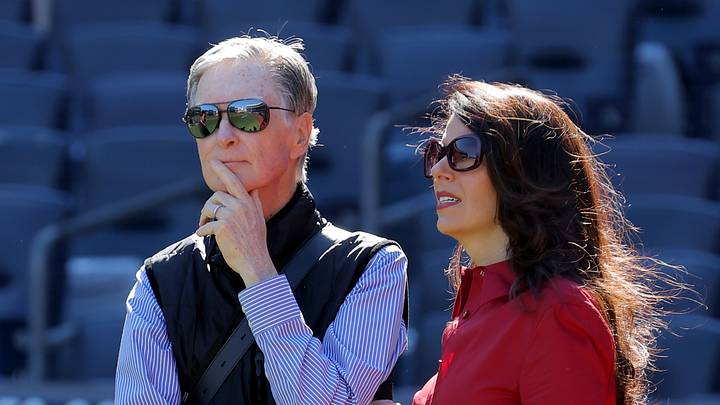 Oct 1, 2025; Bronx, New York, USA; Boston Red Sox owner John Henry (left) stands on the field with his wife Linda Pizzuti Henry during batting practice before game two of the Wildcard round of the 2025 MLB playoffs against the New York Yankees at Yankee Stadium. Mandatory Credit: Brad Penner-Imagn Images