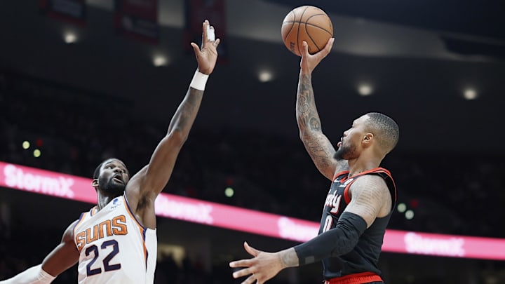 Dec 14, 2021; Portland, Oregon, USA; Portland Trail Blazers point guard Damian Lillard (0) shoots