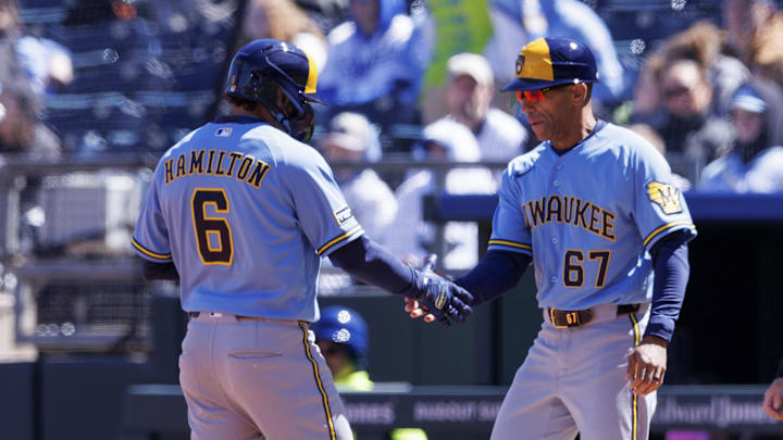 Apr 4, 2026; Kansas City, Missouri, USA; Milwaukee Brewers first base coach Spencer Allen (67) slaps hands with Milwaukee Brewers second baseman David Hamilton (6) after a base hit during the second inning against the Kansas City Royals at Kauffman Stadium. Mandatory Credit: William Purnell-Imagn Images