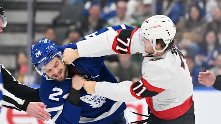 Mar 15, 2025; Toronto, Ontario, CAN;  Ottawa Senators forward Ridly Greig (71) lands a punch on Toronto Maple Leafs forward Scott Laughton (24) as they fight in the second period at Scotiabank Arena. Mandatory Credit: Dan Hamilton-Imagn Images