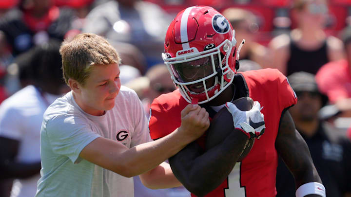 Georgia wide receiver Zachariah Branch (1) works on ball security Georgia coach Kirby Smart’s son Andrew Smart during warms up before the start of a NCAA college football game against Marshall in Athens, Ga., on Saturday, August. 30, 2025. Georgia wide receiver Zachariah Branch (1) works on ball security Georgia coach Kirby Smart’s son Andrew Smart during warms up before the start of a NCAA college football game against Marshall in Athens, Ga., on Saturday, August. 30, 2025.