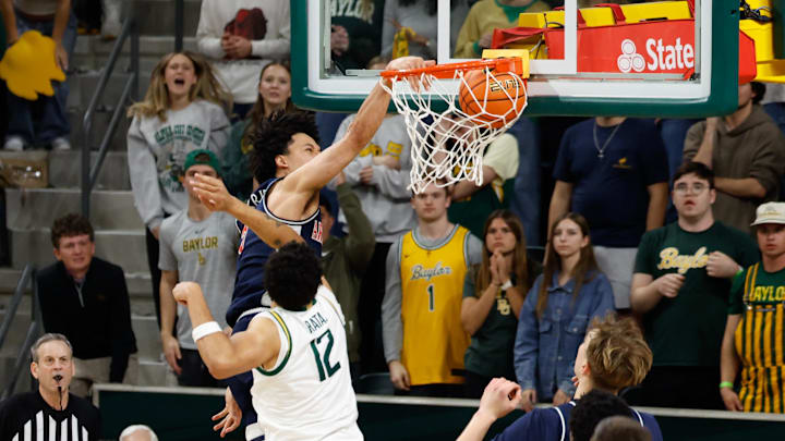 Feb 24, 2026; Waco, Texas, USA; Arizona Wildcats guard Brayden Burries (5) dunks the ball against Baylor Bears guard Michael Rataj (12)  during the second half at Paul and Alejandra Foster Pavilion. Mandatory Credit: Chris Jones-Imagn Images