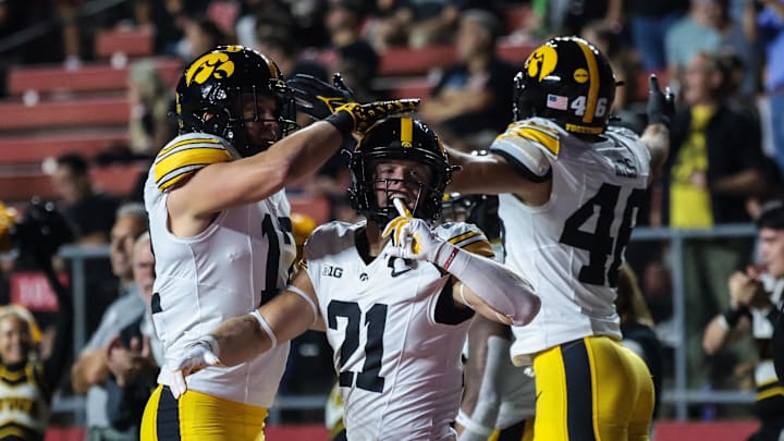 Sep 19, 2025; Piscataway, New Jersey, USA; Iowa Hawkeyes wide receiver Kaden Wetjen (21) celebrates with teammates after returning the opening kick off for a touchdown during the first quarter against the Rutgers Scarlet Knights at SHI Stadium. Mandatory Credit: Vincent Carchietta-Imagn Images