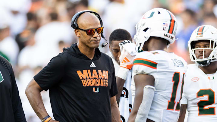 Miami Hurricanes defensive line coach Jason Taylor talks with Miami Hurricanes defensive lineman Elijah Alston (11) during a timeout against the Florida Gators during the second half at Ben Hill Griffin Stadium last season. Miami Hurricanes defensive line coach Jason Taylor talks with Miami Hurricanes defensive lineman Elijah Alston (11) during a timeout against the Florida Gators during the second half at Ben Hill Griffin Stadium last season.