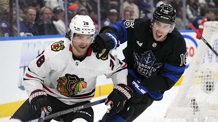 Dec 2, 2024; Toronto, Ontario, CAN; Toronto Maple Leafs forward Mitch Marner (16) and Chicago Blackhawks defenseman TJ Brodie (78) battle for position during the third period at Scotiabank Arena. Mandatory Credit: John E. Sokolowski-Imagn Images