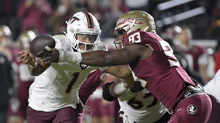 Nov 15, 2025; Tallahassee, Florida, USA; Virginia Tech Hokies quarterback Kyron Drones (1) has the ball knocked away by Florida State Seminoles defensive lineman Mandrell Desir (93) during the second half at Doak S. Campbell Stadium. Mandatory Credit: Melina Myers-Imagn Images