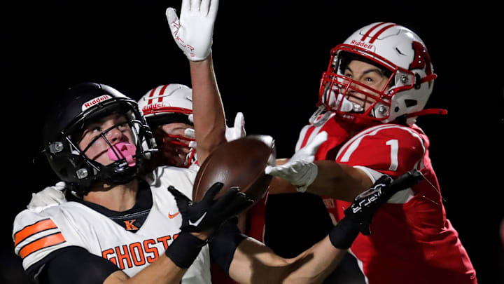 Kimberly's Brennen Resch, partially blocked from view, and Benny Kieffer (1) break up a pass intended for Kaukauna's Parker Schuh (9) on October 11, 2024.