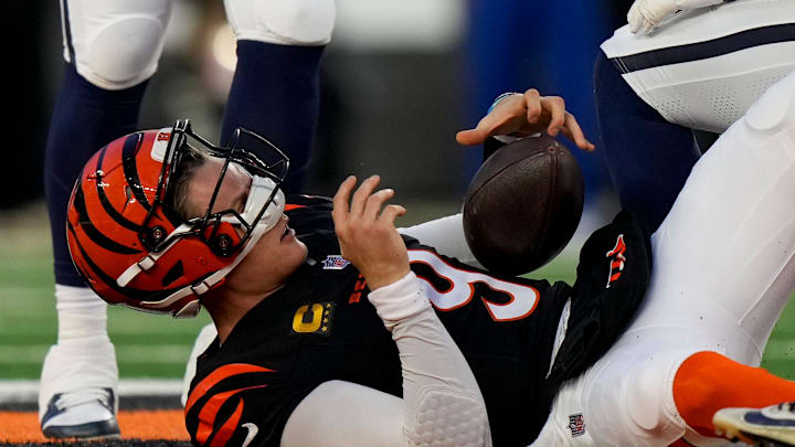 Cincinnati Bengals quarterback Joe Burrow (9) adjusts his helmet after is is knocked loose on a play in the second quarter of the NFL Week 17 game between the Cincinnati Bengals and the Denver Broncos at Paycor Stadium in downtown Cincinnati on Saturday, Dec. 28, 2024.