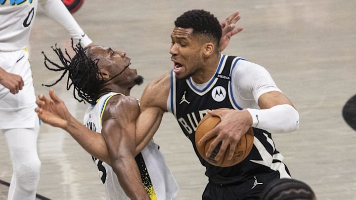 Apr 19, 2025; Indianapolis, Indiana, USA; Milwaukee Bucks forward Giannis Antetokounmpo (34) dribbles the ball while Indiana Pacers forward Aaron Nesmith (23) defends in the first half at Gainbridge Fieldhouse. Mandatory Credit: Trevor Ruszkowski-Imagn Images Apr 19, 2025; Indianapolis, Indiana, USA; Milwaukee Bucks forward Giannis Antetokounmpo (34) dribbles the ball while Indiana Pacers forward Aaron Nesmith (23) defends in the first half at Gainbridge Fieldhouse. Mandatory Credit: Trevor Ruszkowski-Imagn Images