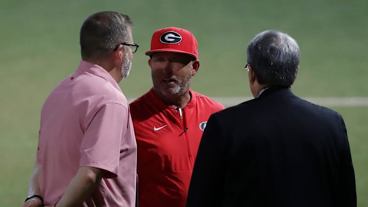 Georgia coach Wes Johnson speaks with Athletic Director Josh Brooks and UGA president Jere W. Morehead after winning a NCAA Athens Regional baseball game against UNCW in Athens, Ga., on Saturday, June 1, 2024. Georgia won 11-2.