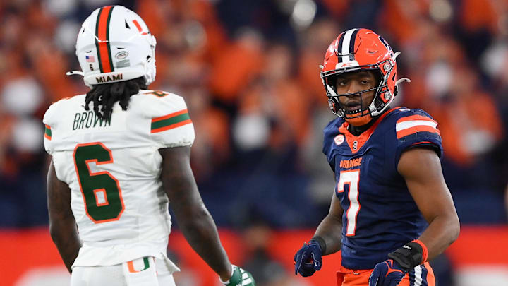 Nov 30, 2024; Syracuse, New York, USA; Syracuse Orange wide receiver Jackson Meeks (7) reacts to a play as Miami Hurricanes defensive back Damari Brown (6) looks on during the second half at the JMA Wireless Dome. Mandatory Credit: Rich Barnes-Imagn Images