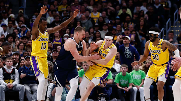 Mar 14, 2025; Denver, Colorado, USA; Los Angeles Lakers guard Austin Reaves (15) steals the ball away from Denver Nuggets center Nikola Jokic (15) as center Christian Koloko (10) and guard Jordan Goodwin (30) defend in the fourth quarter at Ball Arena. Mandatory Credit: Isaiah J. Downing-Imagn Images Mar 14, 2025; Denver, Colorado, USA; Los Angeles Lakers guard Austin Reaves (15) steals the ball away from Denver Nuggets center Nikola Jokic (15) as center Christian Koloko (10) and guard Jordan Goodwin (30) defend in the fourth quarter at Ball Arena. Mandatory Credit: Isaiah J. Downing-Imagn Images
