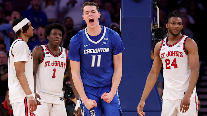 Mar 15, 2025; New York, NY, USA; Creighton Bluejays center Ryan Kalkbrenner (11) celebrates his basket and a foul during the second half against St. John's Red Storm guards Aaron Scott (0) and Kadary Richmond (1) and forward Zuby Ejiofor (24) at Madison Square Garden. Mandatory Credit: Brad Penner-Imagn Images